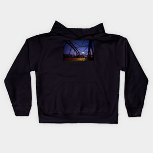 Perspective of an iron bridge with car light trails at twilight in Berlin, Germany Kids Hoodie